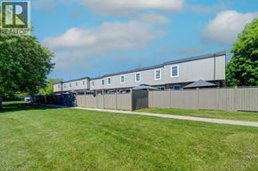 Cambridge townhouse for rent - A row of houses with a grassy front yard.