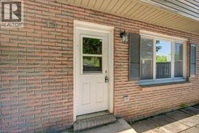 Cambridge townhouse for rent - A house with a white door and a window with blinds.