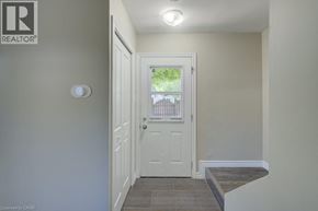 Cambridge townhouse for rent - A white door is in a hallway with a Realtor sign on the wall.