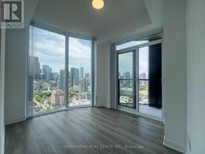 Toronto (Moss Park) condo for rent - A room with a view of the cityscape through large windows.