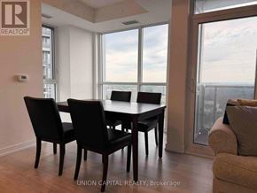 Toronto (Agincourt South-Malvern West) condo for rent - A dining room with a table and chairs and a view of the city.