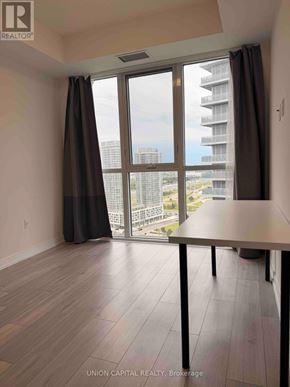 Toronto (Agincourt South-Malvern West) condo for rent - A room with a table and a large window overlooking a cityscape.