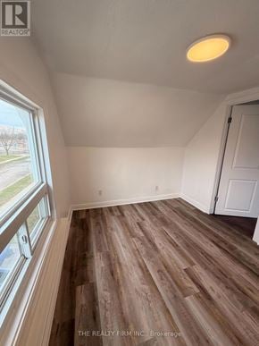 London East (East M) duplex for rent - A room with wooden flooring and a window.
