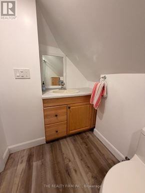 London East (East M) duplex for rent - A bathroom with a sink, mirror, and wooden cabinets.
