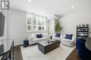 Mississauga (Clarkson) condo for rent - A living room with a white couch, a blue chair, and a coffee table.