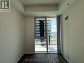 Toronto (Moss Park) condo for rent - A room with a sliding door leading to a balcony.
