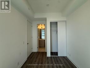 Toronto (Moss Park) condo for rent - A room with a doorway leading to another room.
