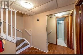 Thorold (Confederation Heights) apartment for rent - A hallway with a staircase and a door leading to a bathroom.