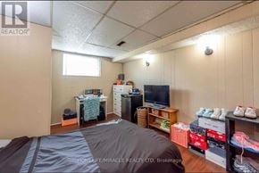 Thorold (Confederation Heights) apartment for rent - A bedroom with a bed, desk, and shelves.