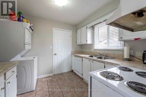 Thorold (Confederation Heights) apartment for rent - A kitchen with white appliances and cabinets.