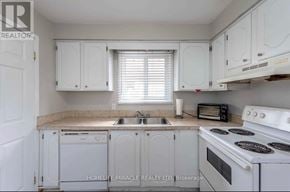 Thorold (Confederation Heights) apartment for rent - A kitchen with white cabinets and appliances.