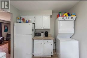 Thorold (Confederation Heights) apartment for rent - A kitchen with white appliances and cabinets.