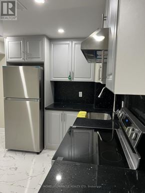 Pickering apartment for rent - A kitchen with a stainless steel refrigerator and black countertops.