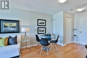 Toronto (Bay Street Corridor) condo for rent - A living room with a white couch, a glass table with four chairs, and a lamp.