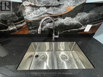 Brampton (Bram West) apartment for rent - A modern kitchen sink with a marble backsplash.