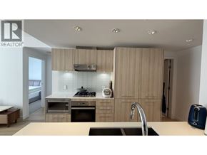 Vancouver apartment for rent - A modern kitchen with wooden cabinets and stainless steel appliances.