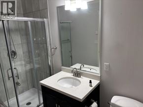 Burnaby apartment for rent - A bathroom with a sink, mirror, toilet and shower.