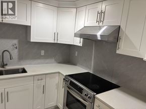 Burnaby apartment for rent - A kitchen with white cabinets and a stainless steel range hood.