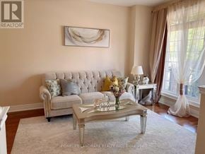 Oakville (Wm Westmount) apartment for rent - A living room with a grey sofa, a coffee table, and a painting on the wall.