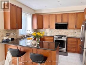 Oakville (Wm Westmount) apartment for rent - A kitchen with brown cabinets and a black stove top oven.