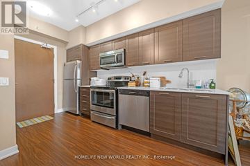 Toronto (Mimico) condo for rent - A modern kitchen with wooden cabinets and stainless steel appliances.