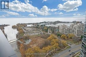 Toronto (Mimico) condo for rent - A view from a high-rise building looking down at a river and a bridge.