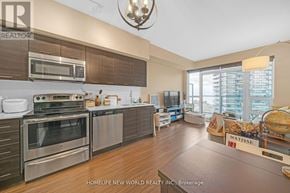 Toronto (Mimico) condo for rent - A modern kitchen with stainless steel appliances and wooden floors.