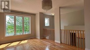 Toronto (Clairlea-Birchmount) townhouse for rent - A room with a large window and wooden flooring.