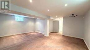 London East (East Q) apartment for rent - A spacious room with a carpeted floor and white walls.