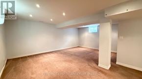 London East (East Q) apartment for rent - A brokerage sign is on the wall in a large empty room.