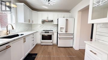 London East (East Q) apartment for rent - A kitchen with white cabinets and appliances.