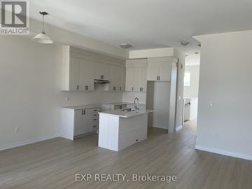 Richmond Hill townhouse for rent - A kitchen with white cabinets and a sink.