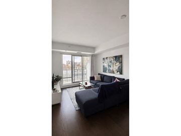 Gatineau (Hull) condo for rent - A living room with a grey couch and a painting on the wall.