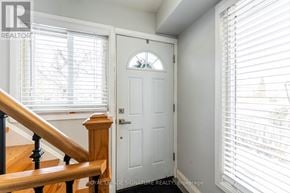 Toronto (West Humber-Clairville) apartment for rent - A white door with a window above it and a staircase to the left.