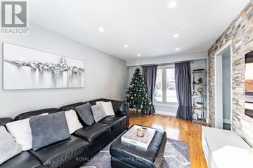 Toronto (West Humber-Clairville) apartment for rent - A living room with a black leather couch and a painting on the wall.