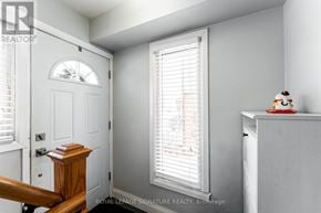 Toronto (West Humber-Clairville) apartment for rent - A white room with a door, a window with blinds, and a small table with a figurine on it.