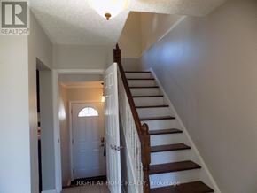 Ottawa apartment for rent - A staircase with a white door at the bottom.