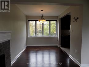 Ottawa apartment for rent - A room with a fireplace and a chandelier.