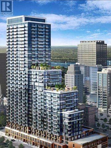 Hamilton (Corktown) condo for rent - A modern high-rise building with balconies and a green roof is depicted in the image.