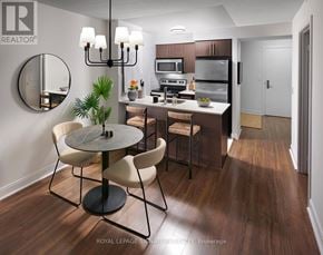 Toronto (Willowdale East) condo for rent - A modern kitchen with a round table and chairs.