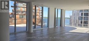 Toronto (Waterfront Communities) condo for rent - A large empty room with a view of the water and buildings outside.
