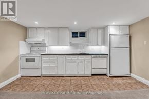 Toronto (Forest Hill South) multi-family for rent - A white kitchen with a tile floor and white appliances.