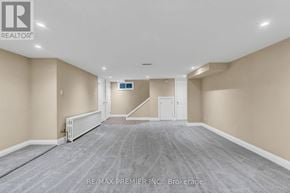 Toronto (Forest Hill South) multi-family for rent - A spacious room with a carpeted floor and a staircase in the background.