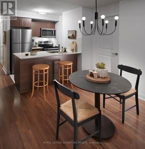Toronto (Willowdale East) condo for rent - A modern kitchen with a dining table and chairs.