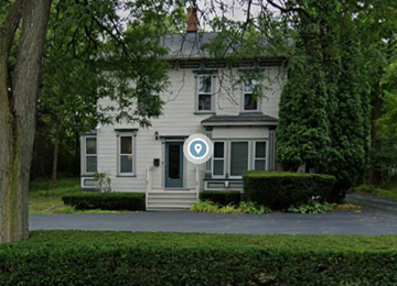 Libertyville apartment for rent - A house with a blue sign in front of it.