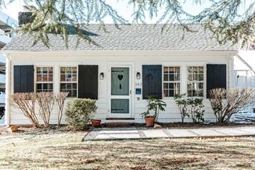 Charlottesville apartment for rent - A small white house with a black front door and windows.