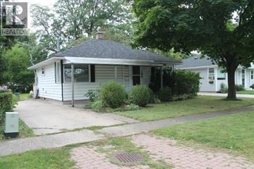 Sarnia apartment for rent - A house with a grey roof and a white house in the background.