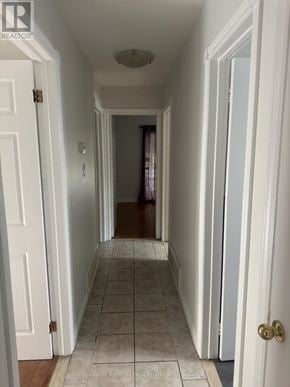 Brampton (Madoc) apartment for rent - A hallway with white walls and a tiled floor.
