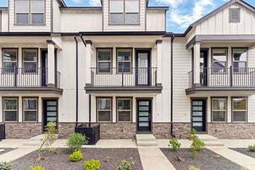 Bend apartment for rent - A row of modern townhouses with black railings and doors.