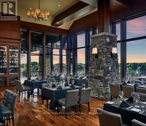 Gravenhurst (Muskoka (S)) condo for rent - A dining room with a stone pillar and chairs.